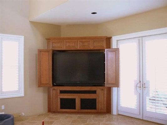 What do you do when you need to fit a TV against a diagonally cut wall? You build a cabinet that fits the wall and TV perfectly.