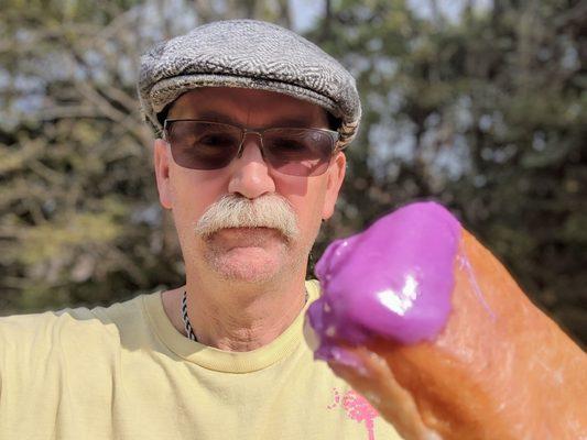 The purple pinky donut from Dunkin' supporting donations for polio vaccines.  Tasty glazed raised bar with a dollop of purple icing.