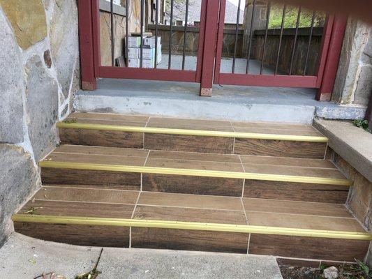 Uneven grout lines, interior trim, unfinished job on porch and steps