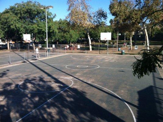 Basketball courts, behind the courts is the space with a few little park exercise machines and a lap to walk/run.