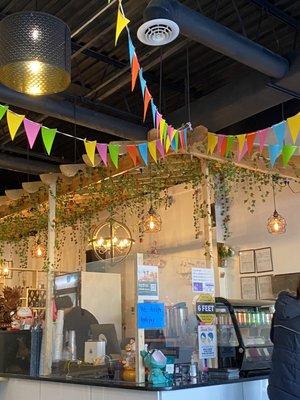 The ceiling with leaves hanging and a colorful banner