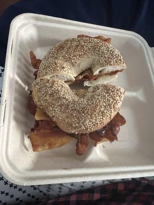 Sesame seed bagel with bacon and cheese