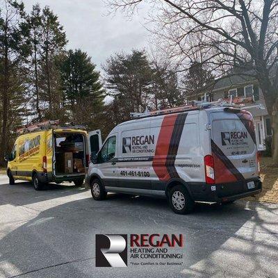 Regan Heating & Air Conditioning vans on location.