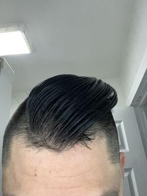 Hair sticking out from sides and front.