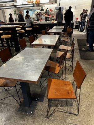 Chipotle dining area.  Dirty tables and floor.