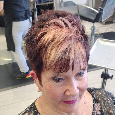 Chocolate cherry base color(touch-up) golden peach highlights (foils) with a short women's textured haircut