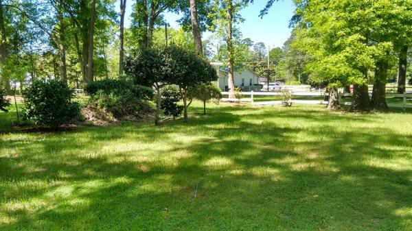 Our Side Yard is an add-on outdoor space featuring an acre and a half of mature trees, garden areas, a gazebo and beautiful archway entries.