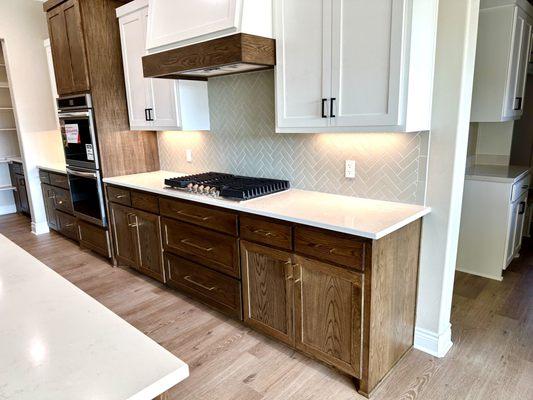 Light sage herringbone tile backsplash in a new build