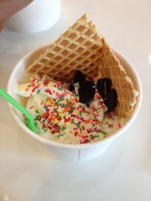 Mango an cheesecake yogurt with Oreos, sprinkles, and waffle cones