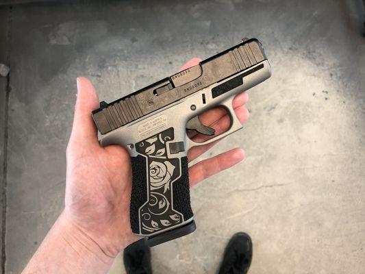 Glock 43x with laser etched slide, laser stippling, hand stippling and framework.