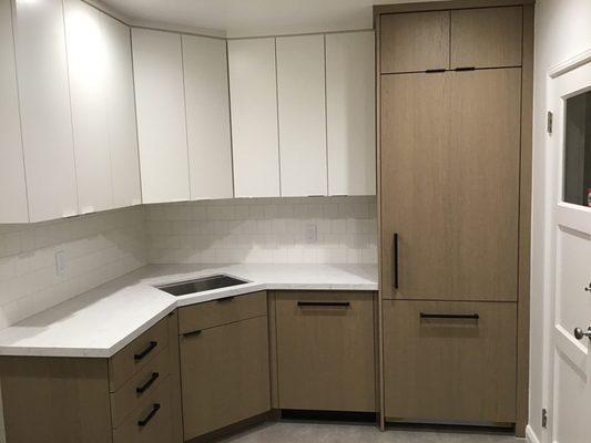 Combination painted and Shinnoki (white oak) cabinets by New Century.