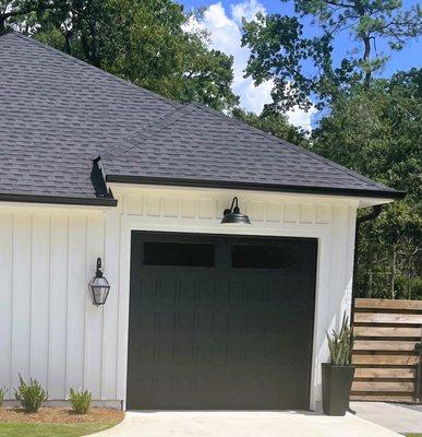 CHI OVERHEAD DOOR IN BLACK SHAKER DESIGN WITH WINDOWS INSTALLED BY THE  GARAGE DOOR INSTALLATION TEAM