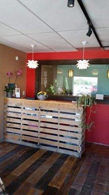 A reception desk made out of a recycled pallet.