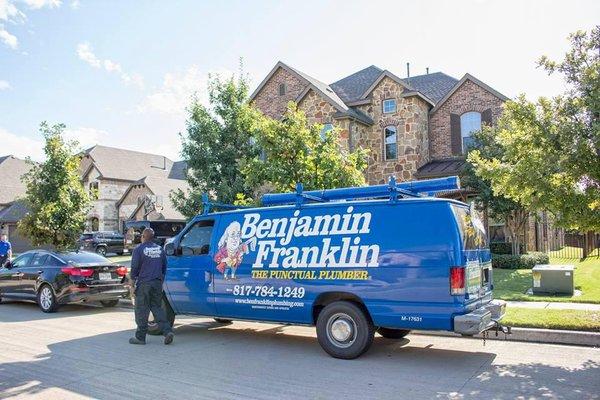 A Benjamin Franklin service vehicle and plumber on a service call near Fort Worth Texas.