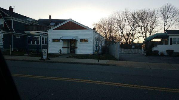 The outside of the business. Right on the main road, with lots of on street parking.