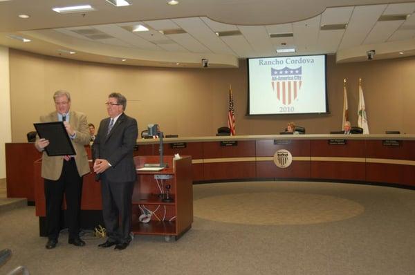 Mayor David Sander presents outgoing Councilman Ken Cooley with a proclamation honoring his service to Rancho Cordova since 2002