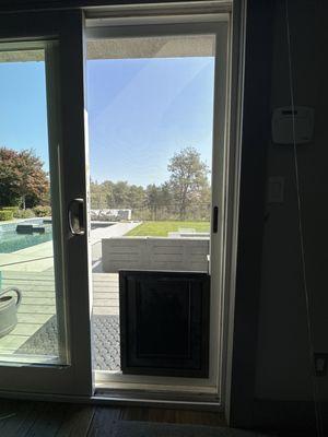 Installed XL Doggie Door in sliding door screen.