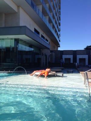 Round outdoor furniture pool lounge on the baby pad area.