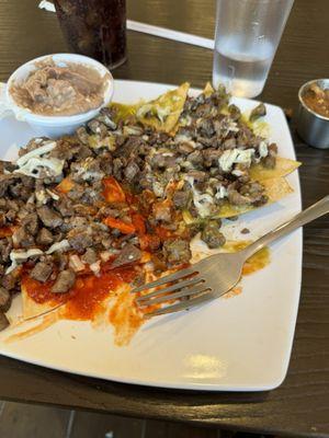 Chilaquiles with carne asada. Divorciados, half green chili and half red. Side beans tasted homemade, just like Nana's.