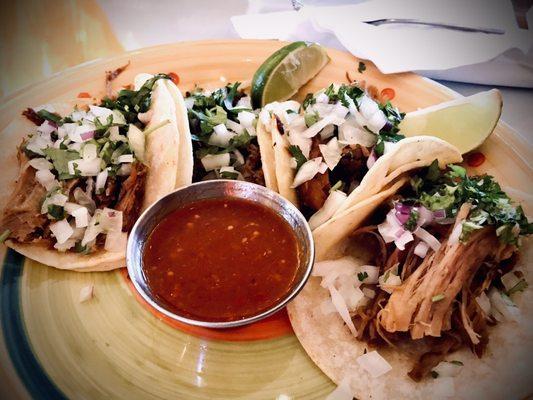 Four carnitas tacos