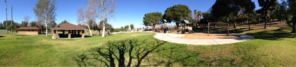 Very nice park! Covered tables seat 60-70 people; playground/jungle gym just behind and several BBQs. Restrooms close by.