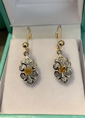 Orange and white diamond earrings designed by Adam