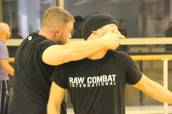 Coach Eric demonstrating a close quarter head control off a punch during a RAW Combat class.