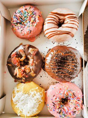 Strawberry sprinkle, lemon with coconut, vanilla with hot fudge glaze, chocolate with bacon, and chocolate Oreo with fudge glaze.