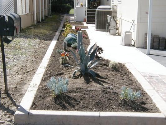 Concrete curb containing a raised planter