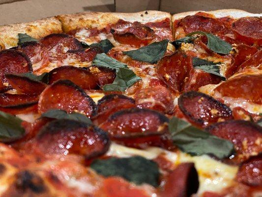 A close up of the pepperoni and sausage pizza.