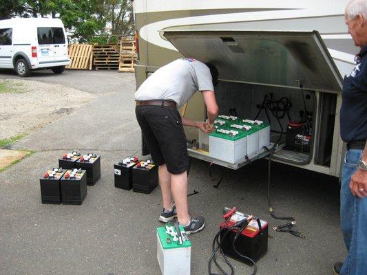 Jeff installing a new set of deep cycle batteries in an RV.