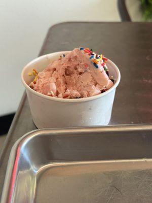 Our daughter's scoop of strawberry ice cream with rainbow sprinkles