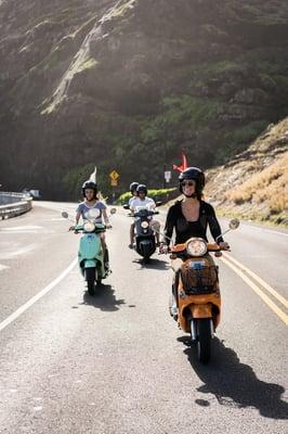 Group of Genuine Scooters riding past Makapu'u.