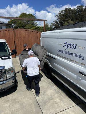 Mark and Jim carrying the dirty couch in for cleaning