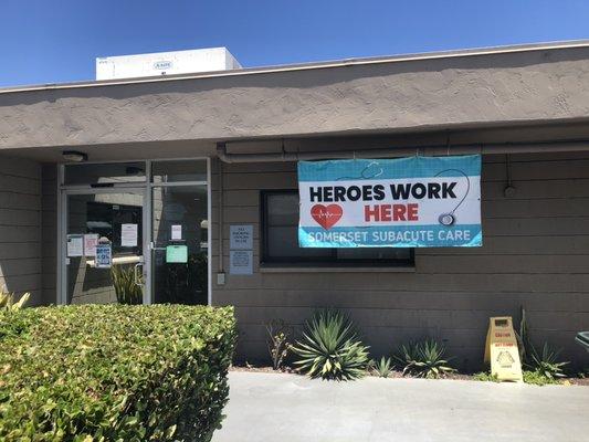 Building entrance "Heroes work here" sign