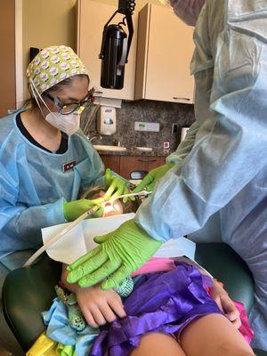 Dr. Suzy is carefully caring for a cavity for youngest daughter who is 5.