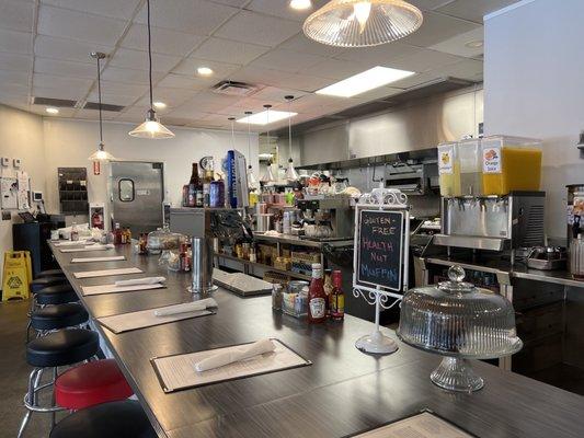 Bar seating and kitchen.