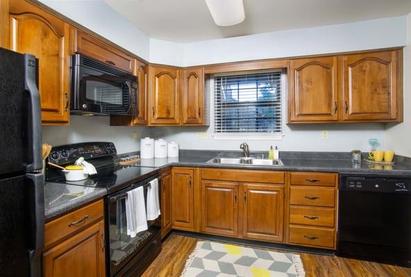 Gourmet kitchen with GE appliances, including a built-in microwave, dishwasher and disposa