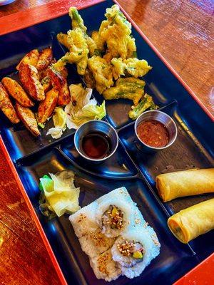 Bento box. California roll, spring rolls, tempura green beans and teriyaki chicken.