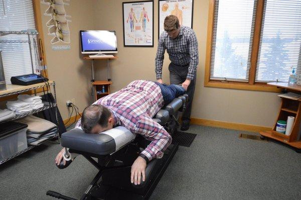 Dr. Rowe giving a chiropractic adjustment