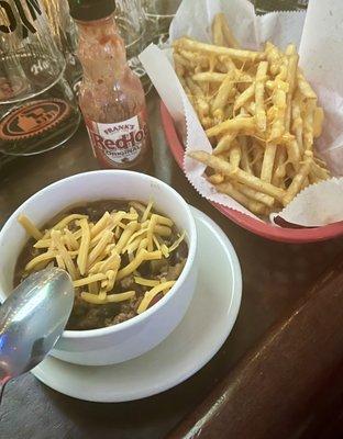 Bowl of chili and fries with cheese