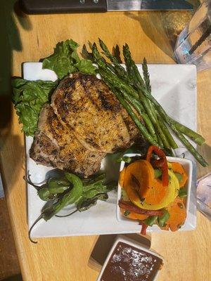 Pork chops with vegetables and asparagus.