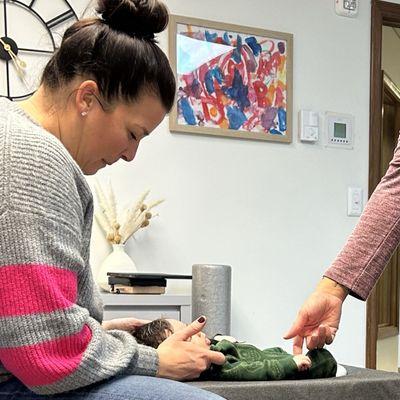 Dr. Ashley adjusting my 8-week-old son