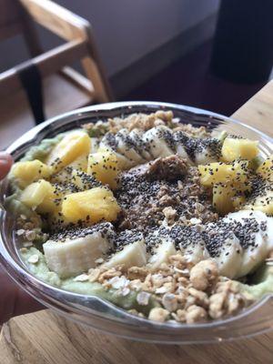 Super Green Bowl, spinach, kale, banana, pineapple, granola, chia seeds, and almond butter.