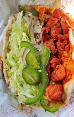 Chicken gyro with lettuce, a little fried peppers and onions. Warm soft pita. Over the top delicious.