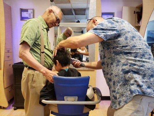 Grandpa standing by for support.