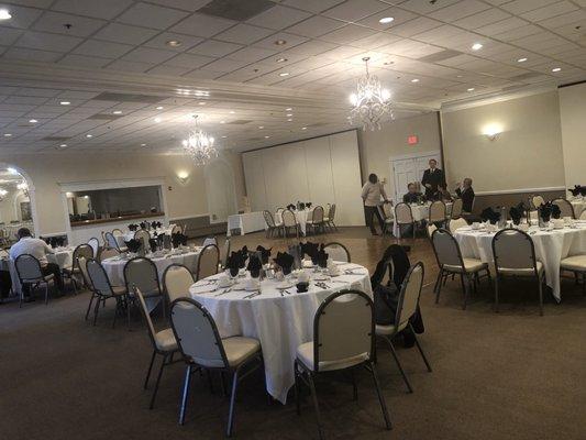 Meeting room set up with view of the dance floor and bar in the back.