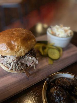 So good, Pulled bork on Brioche  Bun center, house coleslaw and bottom is Kimchi Brussels sprouts