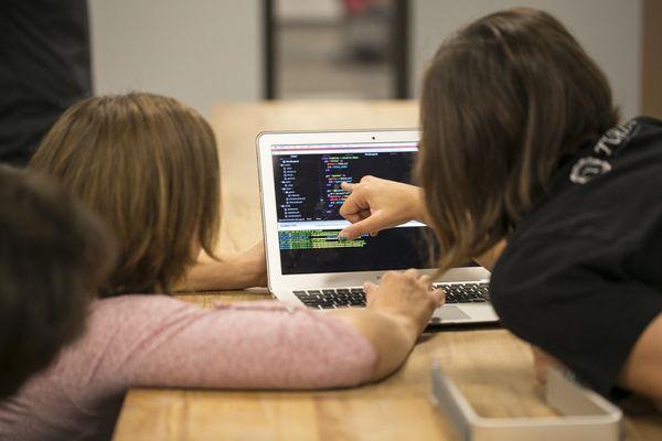 Instructors review a student's code.