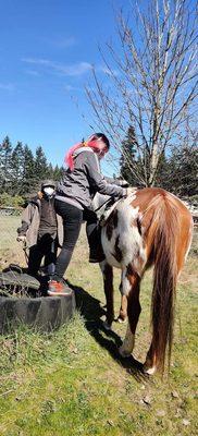 Susan helping Susan onto horse. Taller than they seem!!